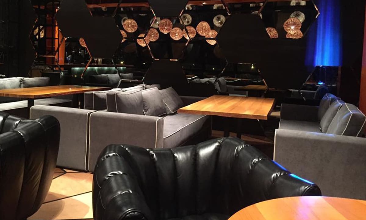 Sleek and modern dining tables at Aura Restaurant designed by Yavorina