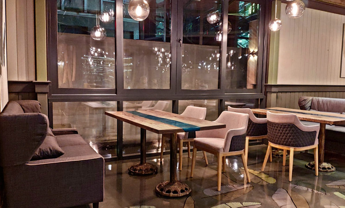 Durable booth seating with integrated tables, crafted for high-traffic family restaurants by Yavorina
