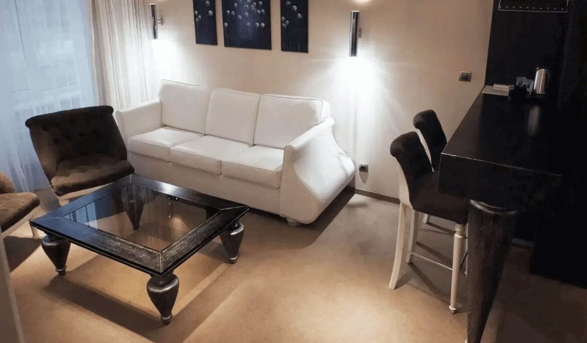 Luxurious wooden bed with upholstered headboard in Orly Park Hotel room - yavorina.com.ua