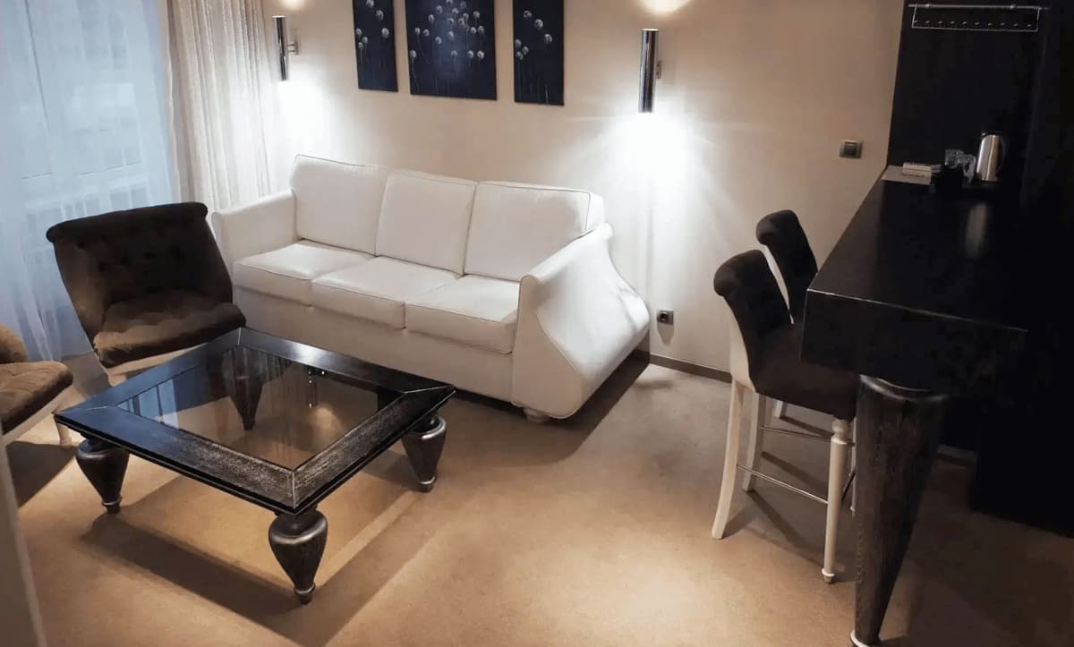 Luxurious wooden bed with upholstered headboard in Orly Park Hotel room - yavorina.com.ua