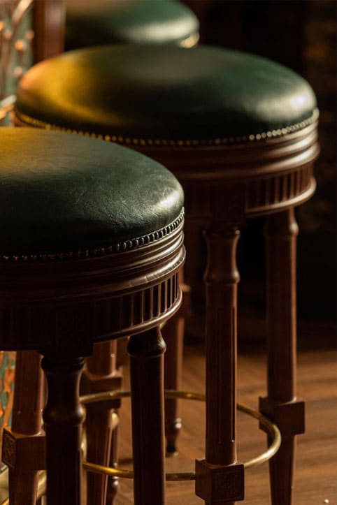 Wooden bar stools with leather upholstery at Bellboy, Berlin - yavorina.com.ua